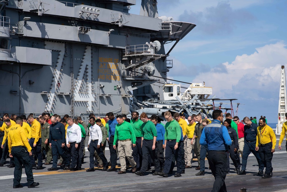 U.S. Sailors participate in a foreign object debris (FOD) walkdown
