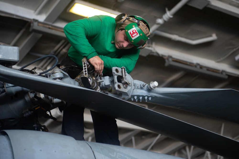 A Sailor conducts maintenance