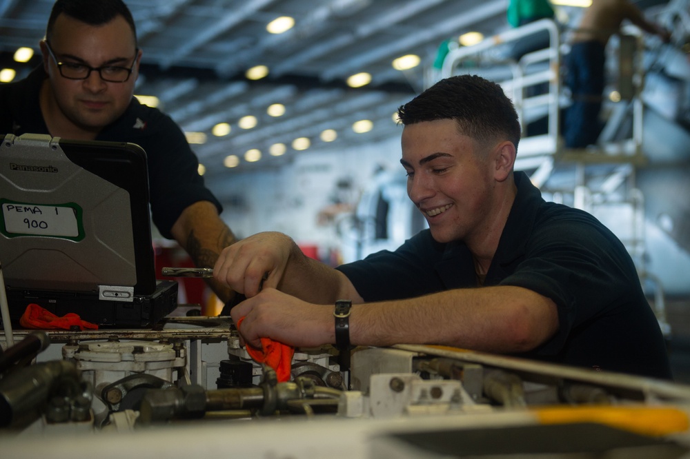 A Sailor conducts maintenance