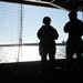 U.S. Navy Master-at-Arms 2nd Class Tammara Diaz, left, from Miami, and Master-at-Arms 2nd Class Devin Cue, right, from Houston, stand watch in the hangar bay