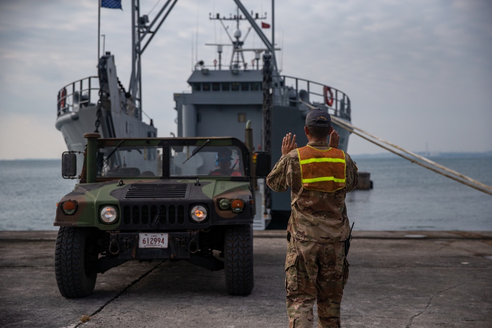 U.S. Marine High Mobility Artillery Rocket System embarks on Army landing craft