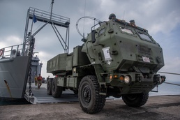 U.S. Marine High Mobility Artillery Rocket System embarks on Army landing craft