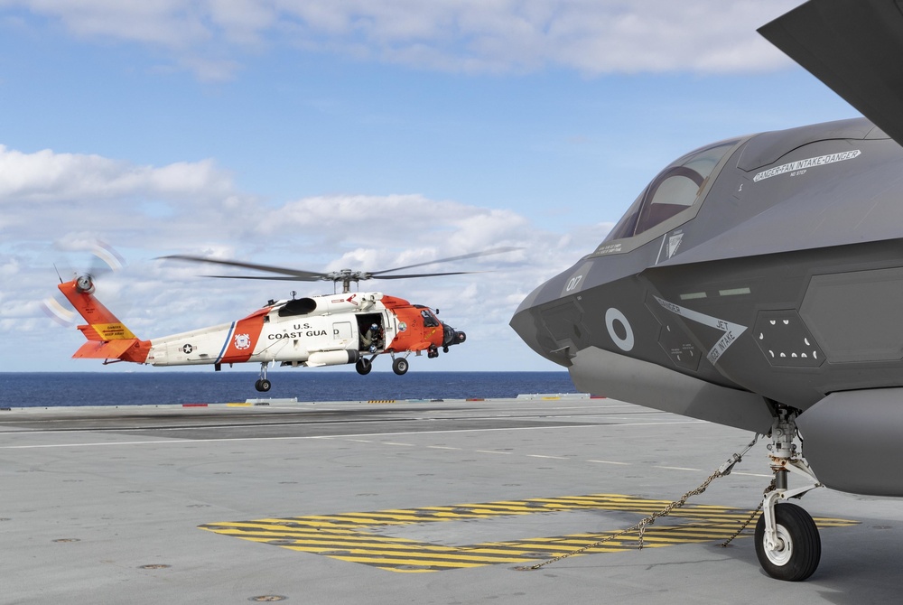 US COASTGUARD HH-60 JAYHAWK HELICOPTER LANDS ONBOARD HMS QUEEN ELIZABETH