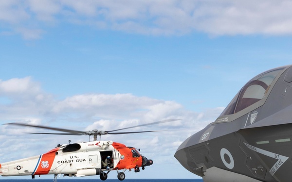 US COASTGUARD HH-60 JAYHAWK HELICOPTER LANDS ONBOARD HMS QUEEN ELIZABETH