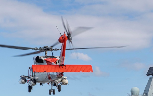 US COASTGUARD HH-60 JAYHAWK HELICOPTER LANDS ONBOARD HMS QUEEN ELIZABETH