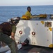 Sailor and Marine attach tow tractor to tow bar