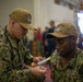 U.S. Navy Hospitalman Bradley Thompson, from Pasco, Washington, checks on a simulated patient during a mass casualty drill