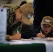 U.S. Navy Aviation Ordnanceman Airman Austin Markham, from Splendora, Texas, fills out an information card.