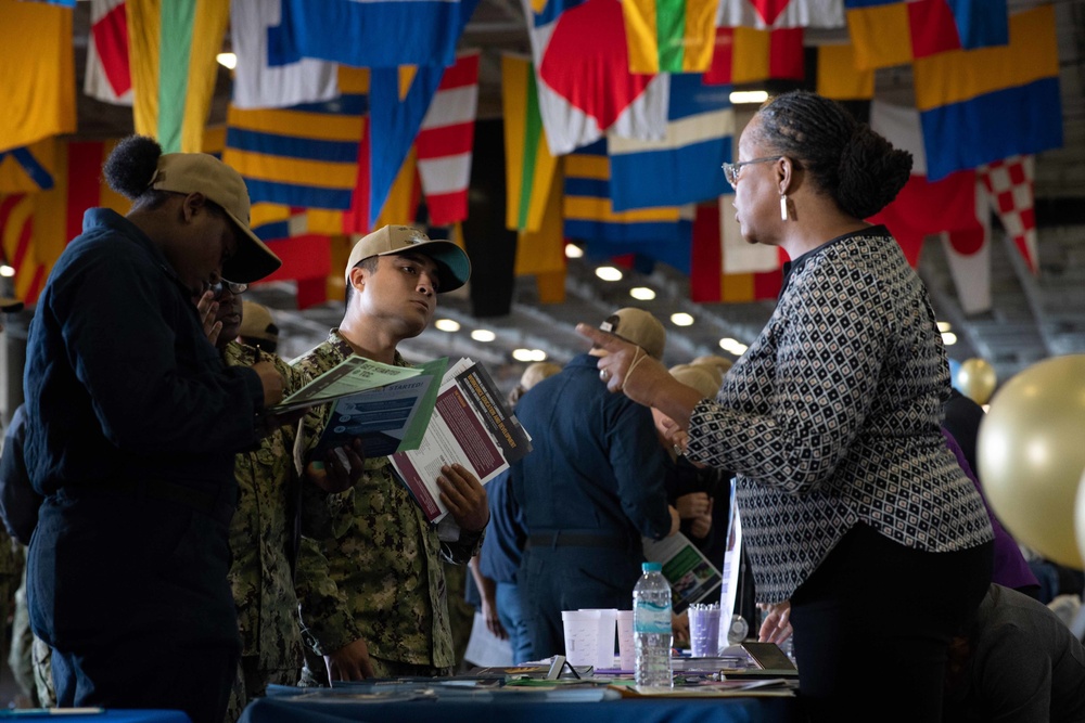 U.S. Sailors attend an education fair