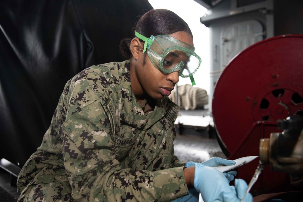 U.S. Sailor conducts fire plug maintenance