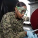 U.S. Sailor conducts fire plug maintenance