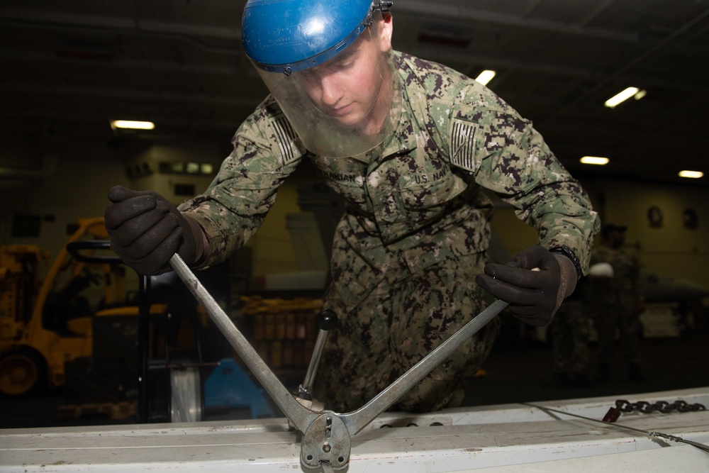 U.S. Sailor bands together metal beams