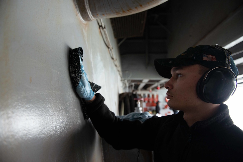 U.S. Sailor cleans bulkhead