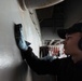 U.S. Sailor cleans bulkhead