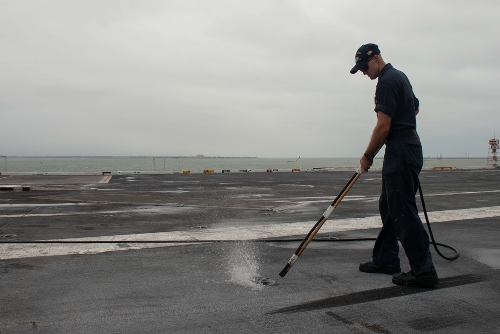 U.S. Sailor cleans padeye