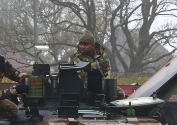 Military enthusiasts watch as French tanks roll into German Town