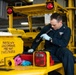 U.S. Sailor inspects a hydraulic pump