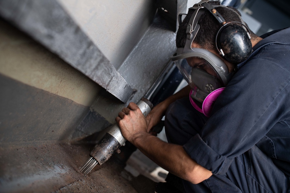 U.S. Sailor conducts deck preservation