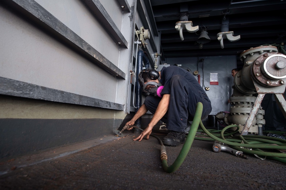 U.S. Sailor grinds the deck