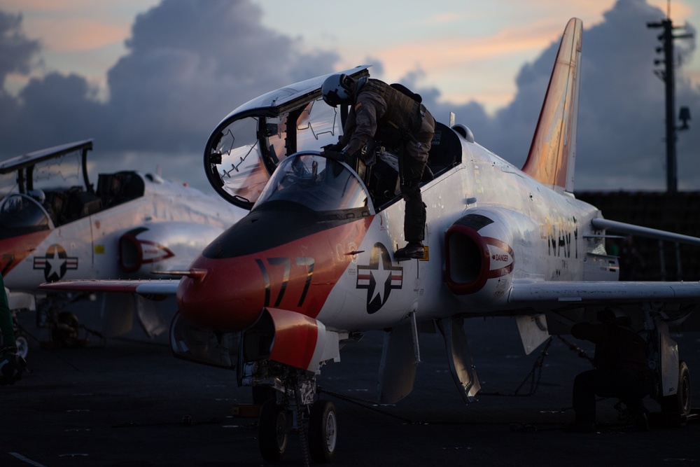 U.S. Sailor climbs into a cockpit