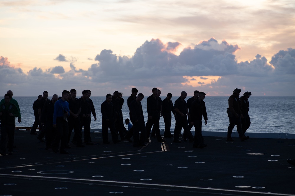 U.S. Sailors conduct a foreign object debris walkdown on the flight deck