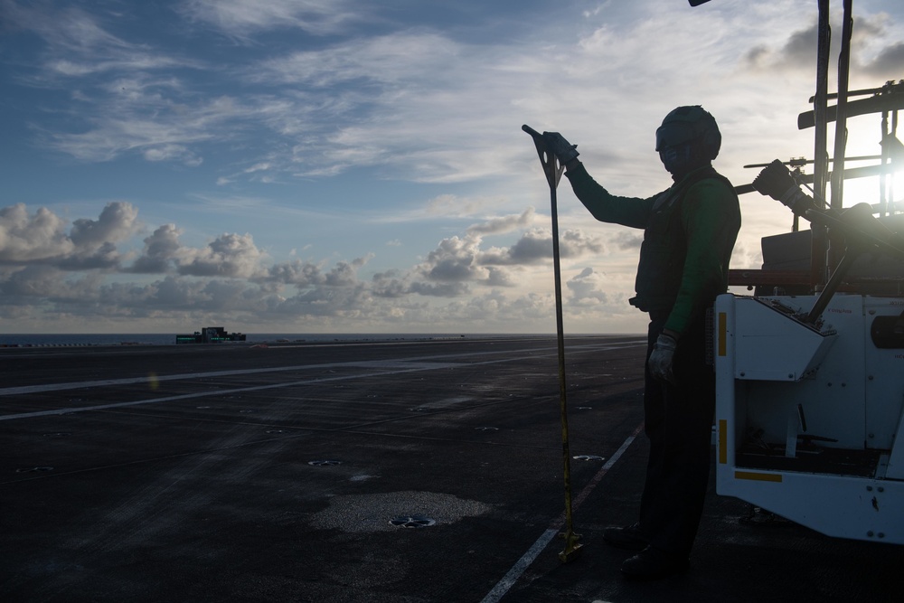 U.S. Sailor observes flight operations