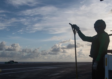 U.S. Sailor observes flight operations