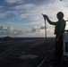 U.S. Sailor observes flight operations