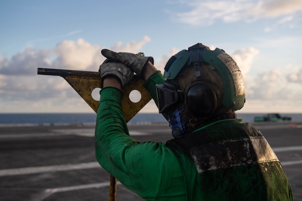 U.S. Sailor observes flight operations