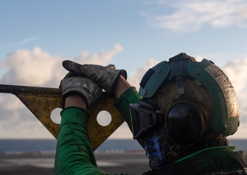 U.S. Sailor observes flight operations