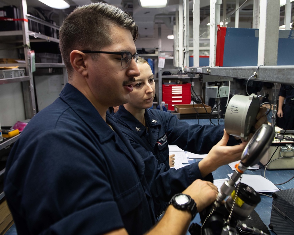 U.S. Sailors calibrate equpiment