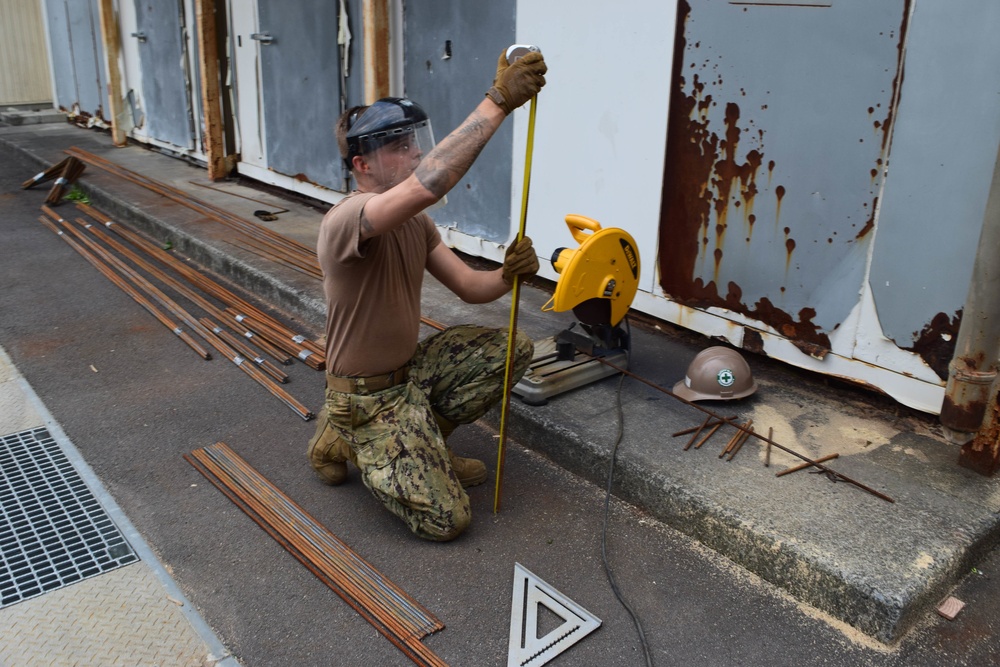 NMCB-5’s Detail Iwakuni excavates environmental trash enclosure project site