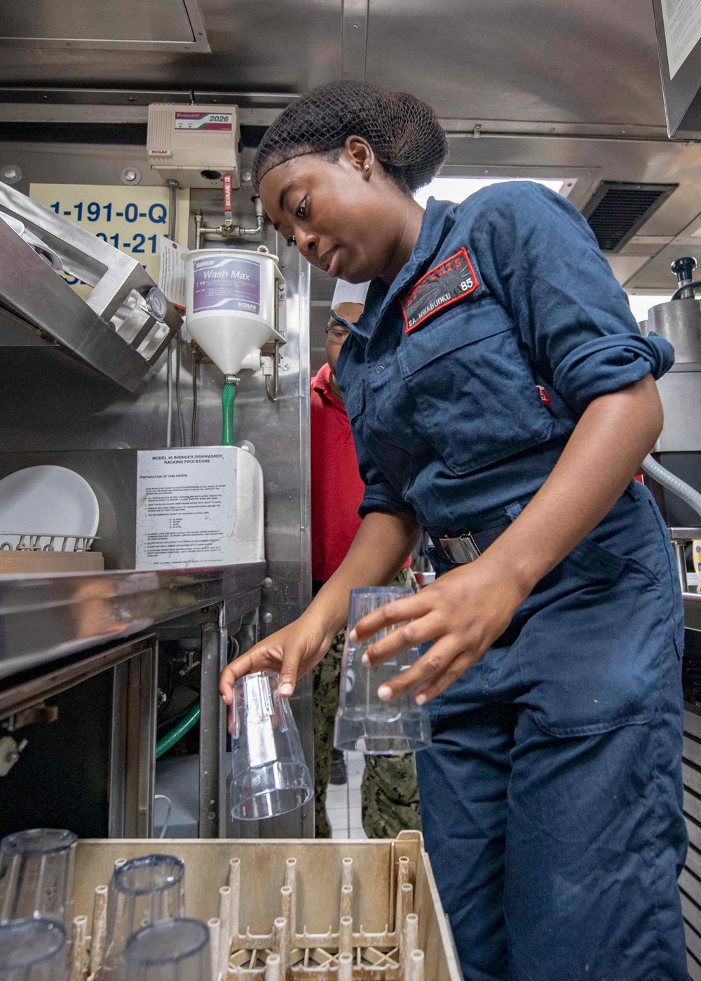 USS McCampbell Sailors prepare meals