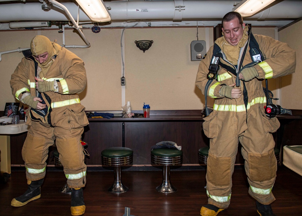 USS Normandy Sailors Don Firefighting Ensembles