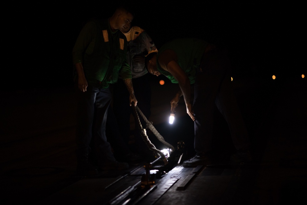 U.S. Sailors conduct a preflight dyno inspection on a catapult on the flight deck of the aircraft carrier USS John C. Stennis (CVN 74)