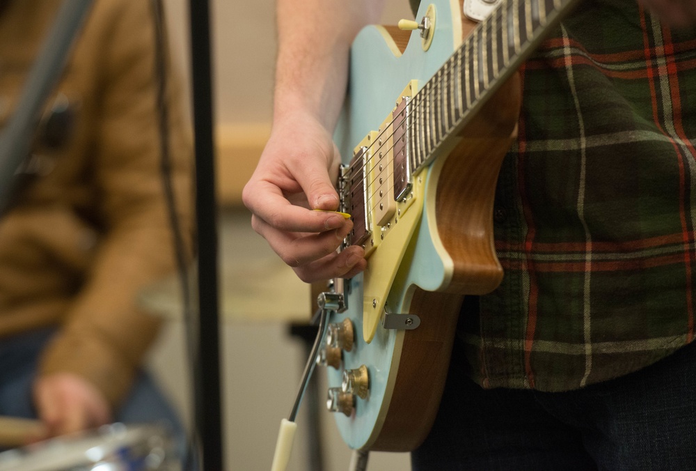 The Squeaks singer Daniel Baldwin strums a guitar at the inaugural Kick Back Day at Whiteman AFB
