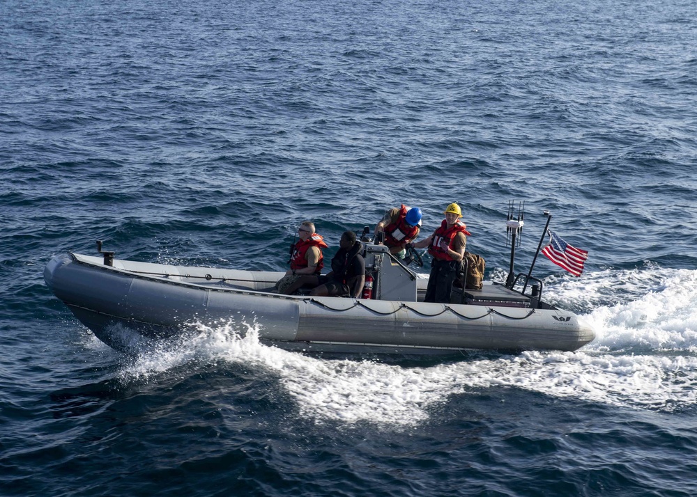 USS Normandy Sailors Ride In RHIB During Swim Call