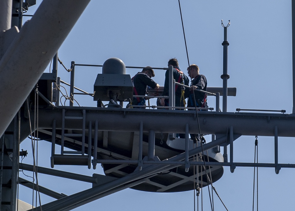 USS Normandy Sailors Perform Maintenance On Surface Search Radar