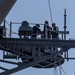 USS Normandy Sailors Perform Maintenance On Surface Search Radar