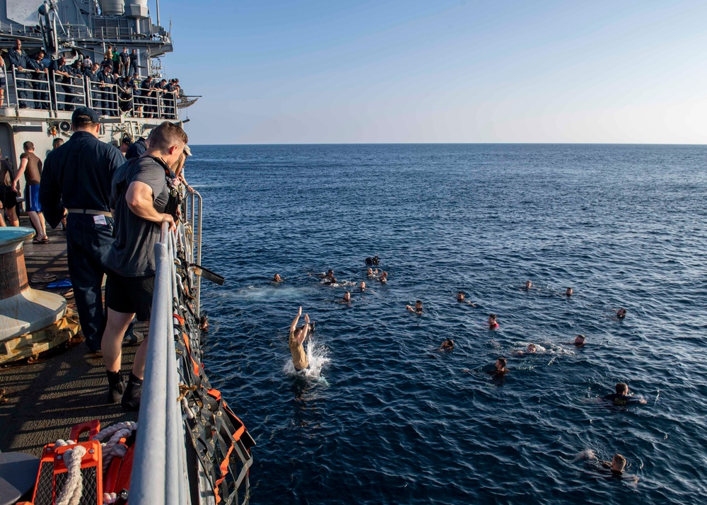 USS Normandy Sailors Swim Beside Ship