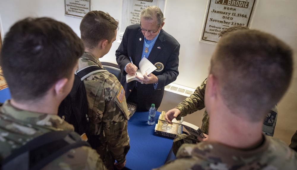 Medal of Honor recipient Patrick Brady signs books for ROTC cadets