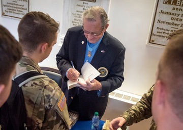 Medal of Honor recipient Patrick Brady signs books for ROTC cadets