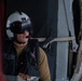 U.S Navy Naval Aircrewman observes flight operations from an MH-60S Sea Hawk