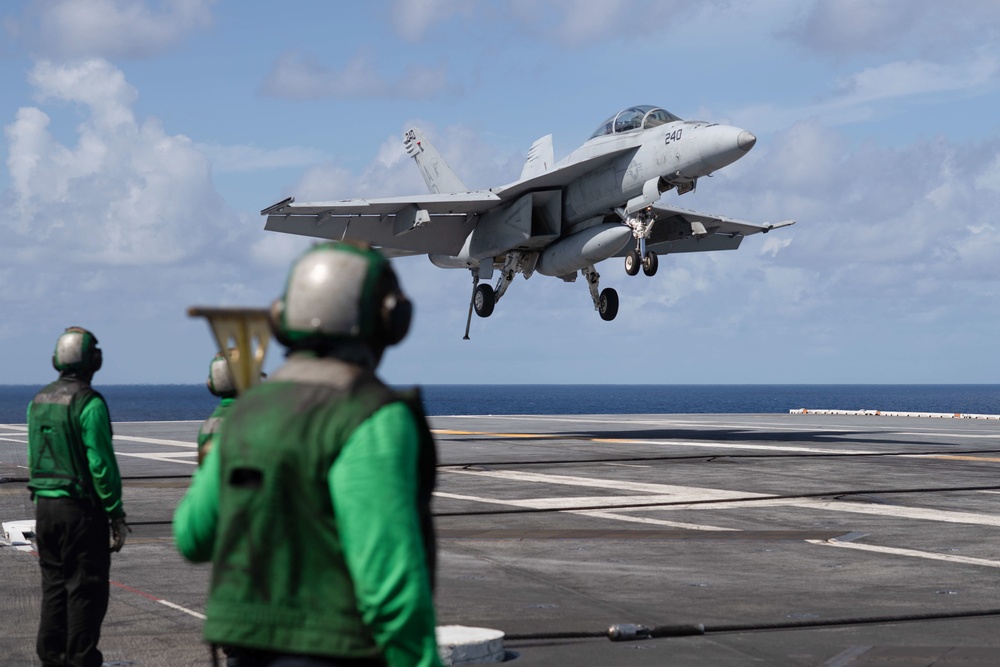 U.S. Navy Aviation Boatswain's Mate (Handling) Airman Apprentice Chris Blaisdell, from Lancaster, California, awaits An F/A-18F Super Hornet