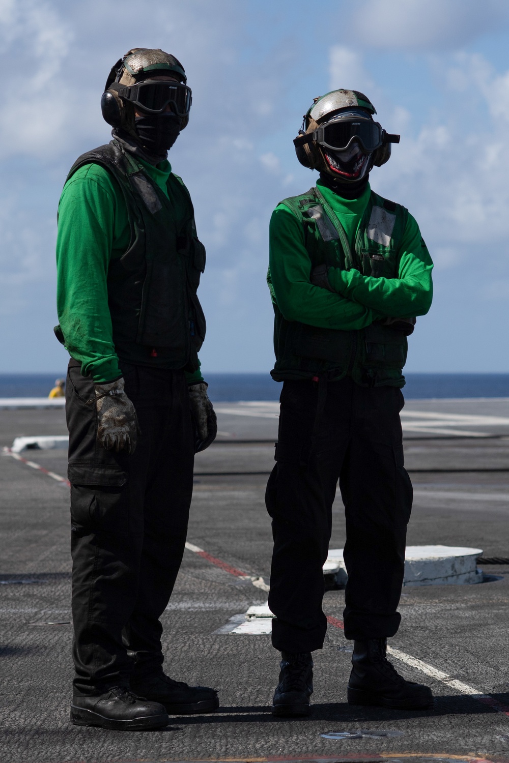 U.S. Navy Aviation Boatswain's Mate (Handling) Airman Apprentice Chris Blaisdell, from Lancaster, California, awaits An F/A-18F Super Hornet