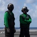 U.S. Navy Aviation Boatswain's Mate (Handling) Airman Apprentice Chris Blaisdell, from Lancaster, California, awaits An F/A-18F Super Hornet