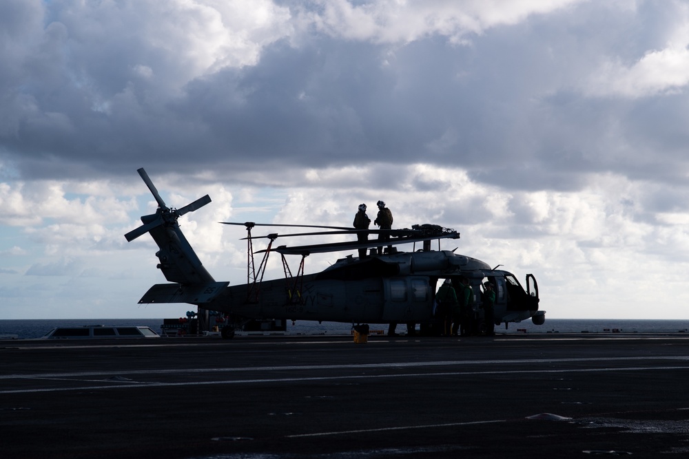 U.S. Sailors conduct preflight checks on an MH-60S Sea Hawk assigned to Helicopter Sea Combat Squadron (HSC) 6