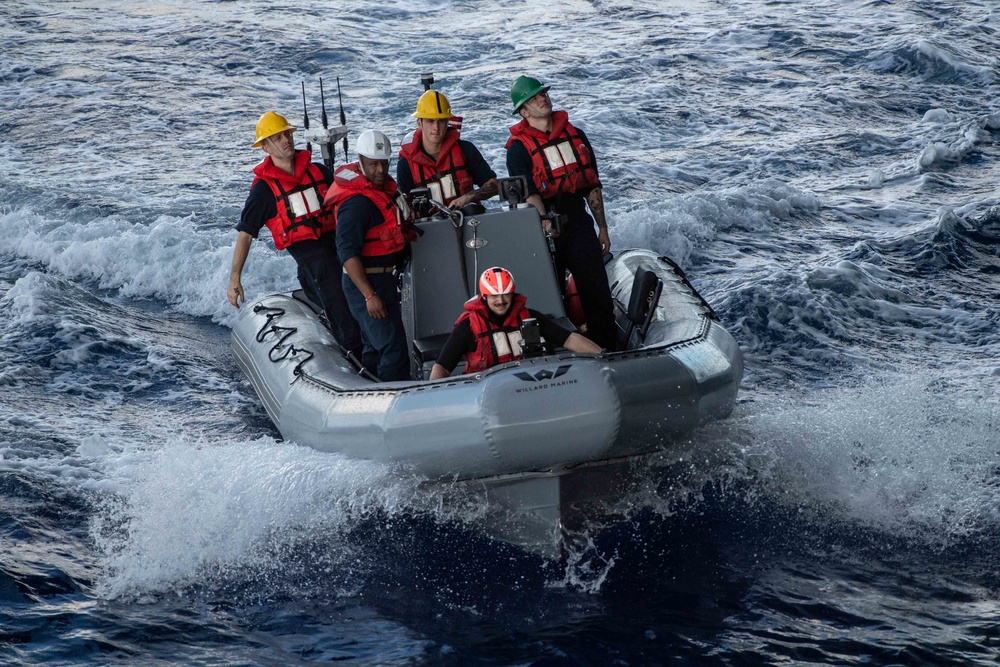 U.S. Sailors operate a rigid-hull inflatable boat