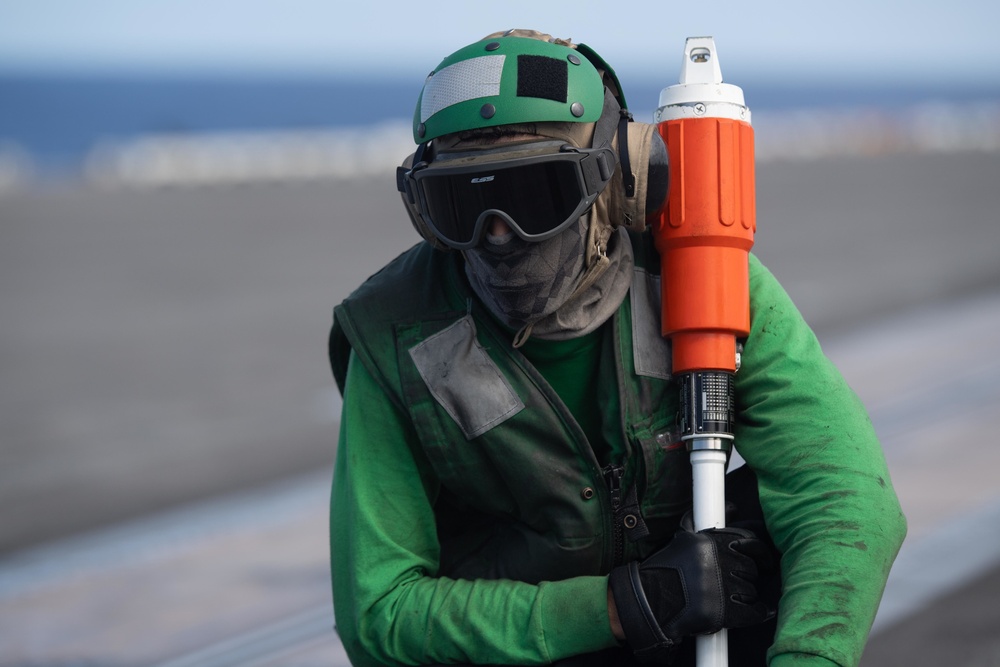 U.S. Sailor observes flight operations