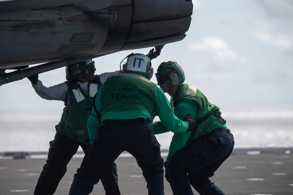 U.S. Sailors prepare an F/A-18F Super Hornet, assigned to Strike Fighter Squadron (VFA) 106, for flight